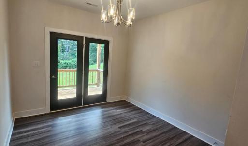Formal DR open to kitchen, French doors lead to large covered deck which overlooks  greenspace in the rear yard