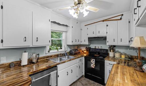 Love the huge window overlooking the pretty back yard and trees. There are 8 brand new windows in the home!