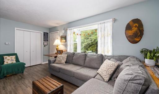 spacious living room off the front door with a wide bow window