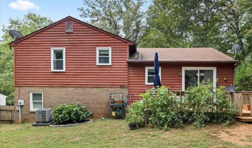 The back of the house! Mature plantings, trees for shade. The new heat pump!