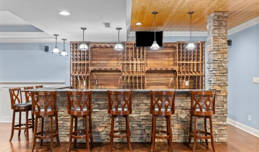 Gorgeous stone bar area that seats 8.  All custom-made wine racks with sink and ice maker