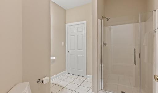 Full bathroom entry from garage and pocket door leads to office/future main level bedroom