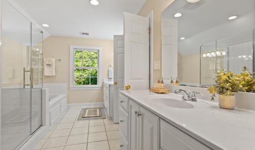 Primary Bathroom separate sinks.  New seamless glass shower and soaking tub