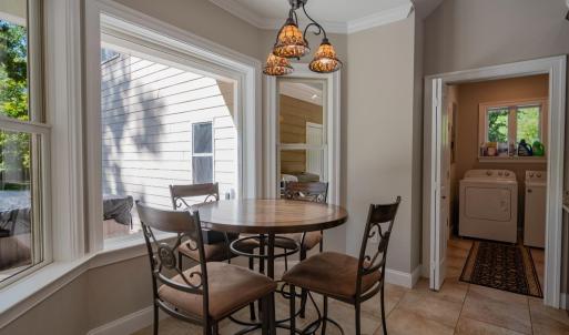Breakfast area overlooks rear yard, hallway to laundry room & half bath