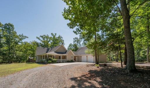Circular driveway is gravel but has a concrete parking area at house
