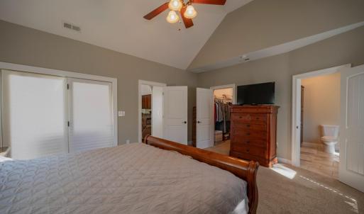 Prinary bedroom looking into pri,ary bath to right and walkin closet to left, door to deck far left