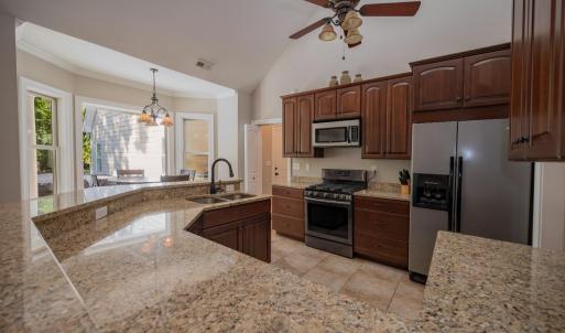 Kitchen showing granite counters & breakfast bar & breakfast area at bay window