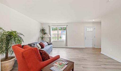 Looking toward the front door. There is a closet under the stairs which houses a full house water filtration system.
