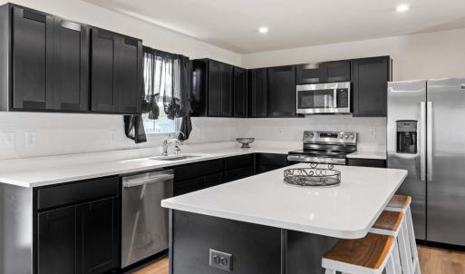 AWESOME KITCHEN with beautiful espresso colored cabinets and granite counters. All appliances convey