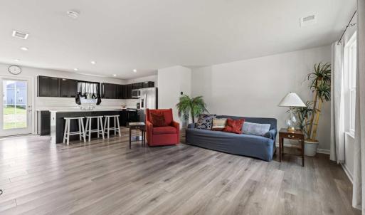 The light from the full glass back door to the full wall of windows in the front of the house creates a wonderful comfortable feeling