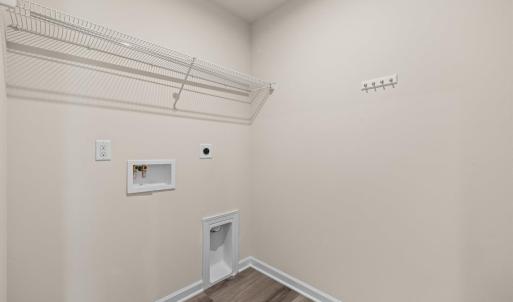 The 6'5"x5'4" laundry room is in the middle of the upstairs hallway between bedrooms 2 and 3