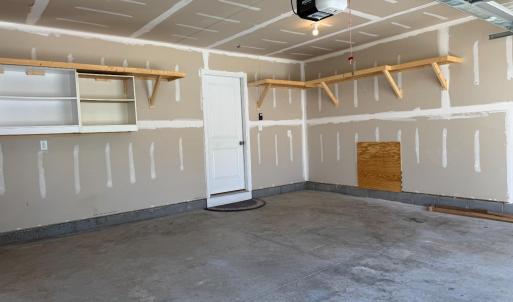Shelves on the back wall and right wall, door to downstairs hallway. The square here is access to the full house water filtration system