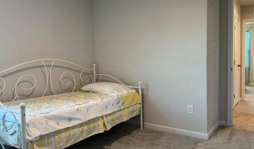 Bedroom 4 flanking the hall bath and large linen closet with Bedroom 3 on the other side.