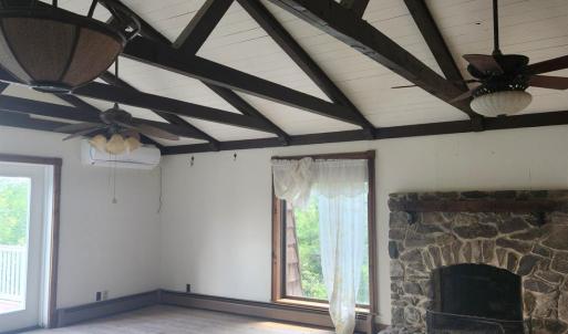 Vaulted ceiling and fireplace in primary bedroom