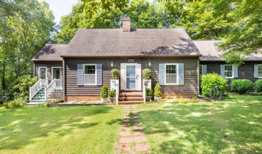 This front view of 11766 Five Forks Road shows front entrance at center, sun room entrance on left and attached garage on the right.