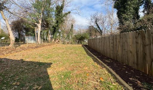 Deep back yard with privacy fence with a sunny garden space ready to plant in!