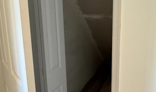 Nice that the seller made the space under the stairs accessible for a great closet!