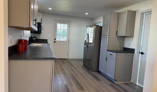The really nice kitchen! Door leads to the back yard (and storage room)