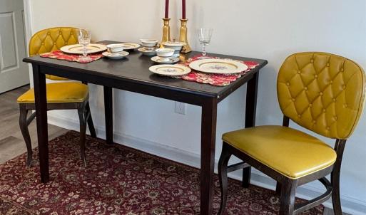 Dining area between the LR and the Kitchen. Here the table is shown tucked against the wall but could easily be centered in the room. The door on the left is the downstairs bedroom