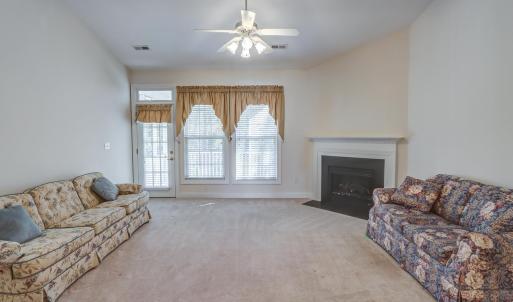 Large great room with electric fireplace opens up to screened porch
