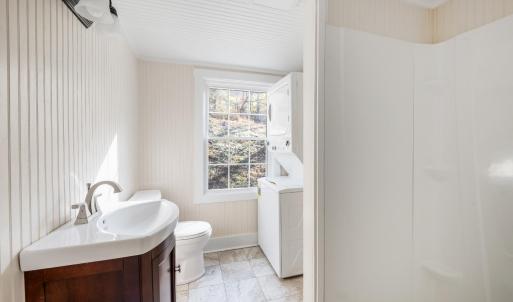 Main level bathroom with stackable W/D