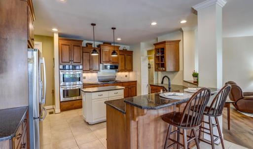 Chef's kitchen open to den and breakfast area