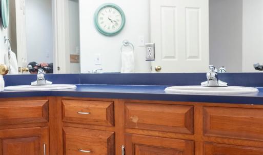 hall bath with 2 sinks and separate tub shower