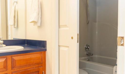 hall bath with 2 sinks and separate tub shower
