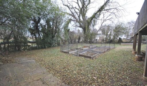 Large fenced in back yard that is tree lined for more privacy