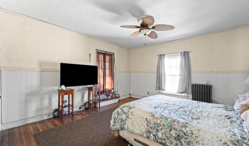 There is a nice large closet on the left. The curtained opening with a step here goes to the sunporch on the back of the house.