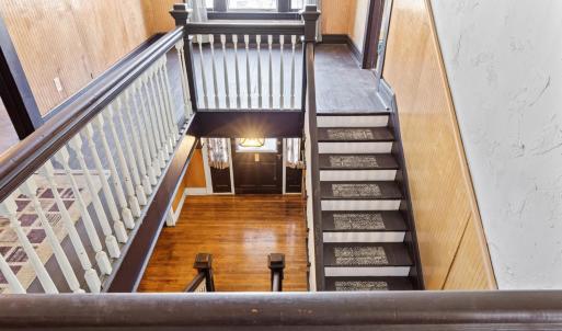 Stopping at the top of the stairs too look down at the nice view of the foyer below.