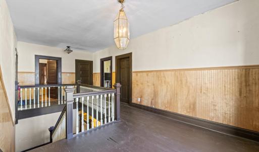 Upstairs the floors have been painted. The rooms follow around the corners of the house. The entrance to Bedroom 2 is to the right in this picture