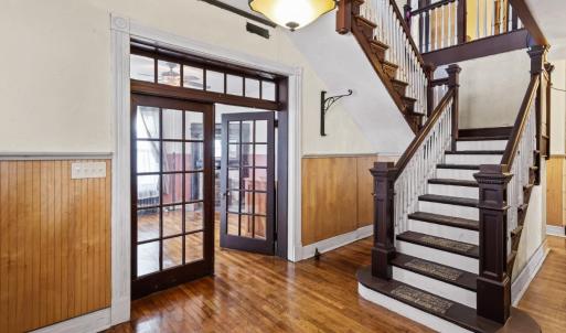Center staircase, matching french door/lights flanking the foyer, restored ceilings and walls throughout.