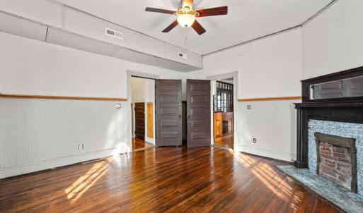 Door on right is the front room off the foyer. Door on left leads to a hallway with downstairs full bath.