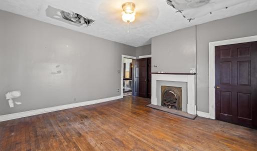 Bedroom 2 is also on the front of the house. This is where the roof on the front needs to have the leak fixed. the door on the right is the closet. There is another passthrough door to the room behind this one just behind this room's entrance door.