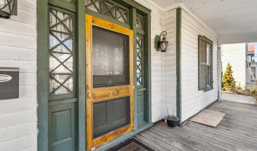 Awesome 40' front porch with new ceiling, floor, pillars, custom screen door, Chippendale lights around 42" front door. Cityscape!