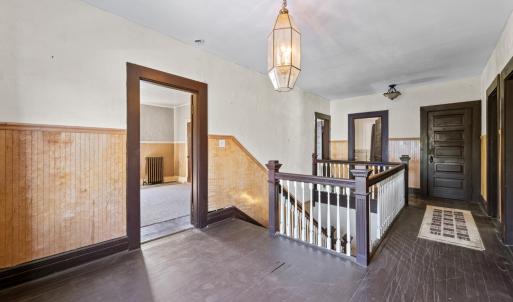 Upstairs and going into the first bedroom at the top of the stairs.