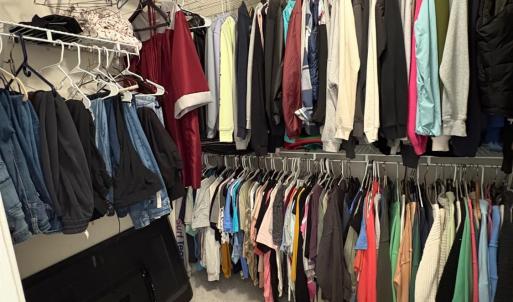 Walk in closet off primary bedroom .