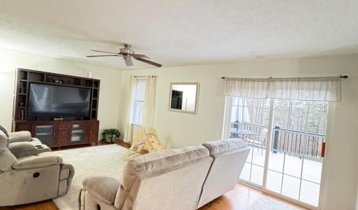Living room on main level with patio doors to deck.