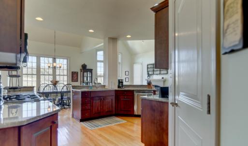 Custom kitchen, gas range, upgraded appliances; pantry, main level laundry room