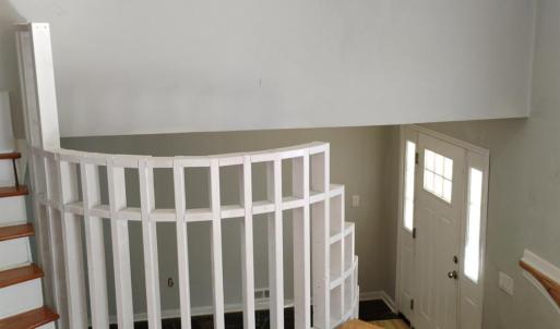 VIEW STANDING IN LIVING ROOM LOOKING DOWN AT FRONT DOOR