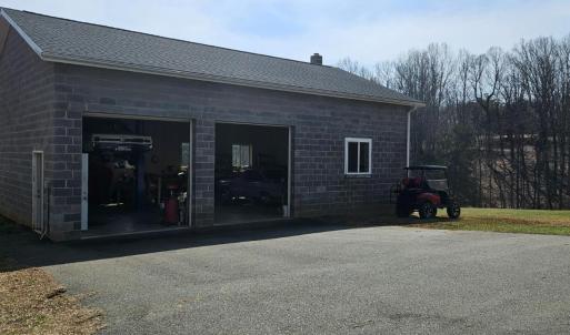 Huge 30' x 44' Garage includes car lift, wood stove & extra work space. This garage can house 4 cars if space to right is utilized, as it is now & still have space for work areas. In ground water line installed but not hook up to garage, but it could be.