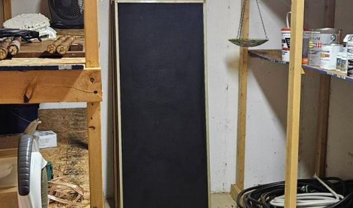 Storage closet off of recreation room has 3 walls of concrete & could make an incredible safe room.