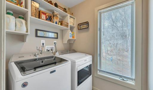 Laundry room located off primary bathroom