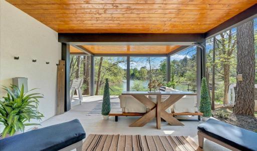 a seamless blend of elegance and openness, this property features expansive outdoor living areas to rival its sophisticated indoor spaces overlooking the breathtaking beauty of Smith Mountain Lake!