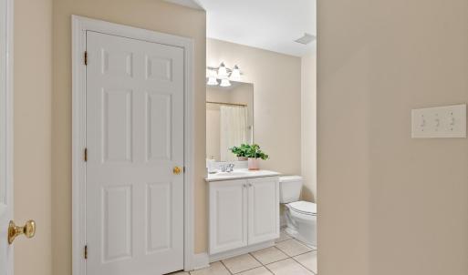 Full bathroom of Bedroom 1 ensuite with pantry space.