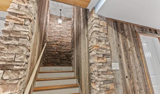 Custom stonework to give a French Cellar feel leading down to the terrace level.