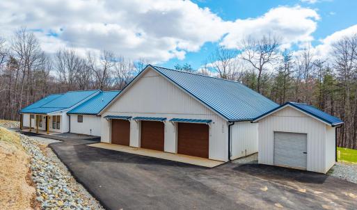 Exterior of Home with paved driveway and storage shed