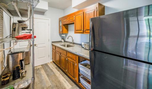 Terrace level kitchen with cherry cabinets, poured concrete counter  top, and huge pantry closet