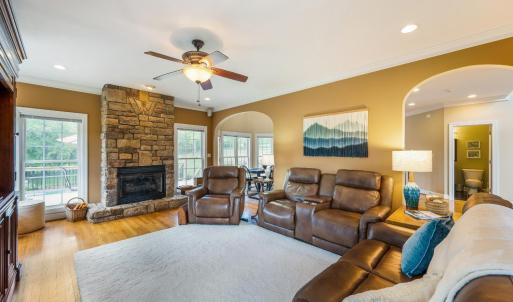 Family room with propane fireplace, tall ceilings, crown molding, surround sound, hardwood floor, arched entry ways and plenty of windows!